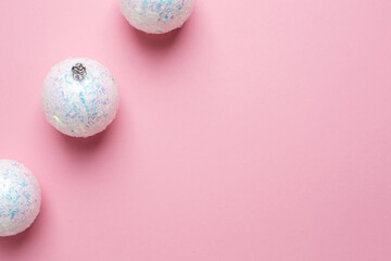 Shiny white balls on a pink background, Christmas decorations with copyspace