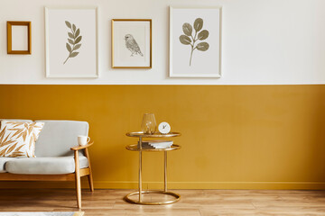 Unique living room in modern style interior with design sofa, elegant gold coffee table, mock up poster frames, flowers in vase, decoration and pesronal accessories in home decor. Template.