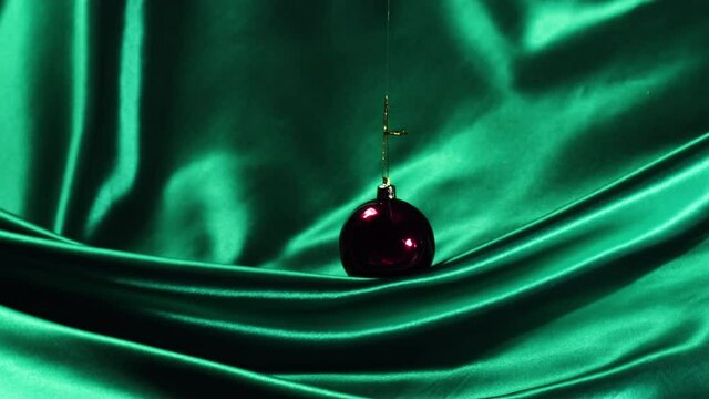 3x clips bundle containing christmas baubles swaying in front of luxurious silk. The material folds in abstract mesmerizing ways. Great for fashion, christmas ads, social posts and more. In stunning 4