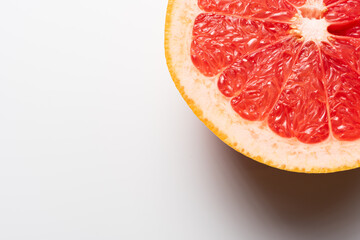 Fresh tasty grapefruit on plate. Half of grapefruit on white background