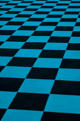 Blue and black checkered carpet leading off into the distance.