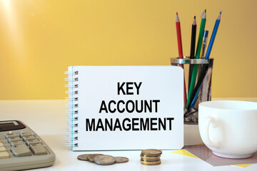 Desktop with documents, calculator and notebook. Inscription KEY ACCOUNT MANAGEMENT