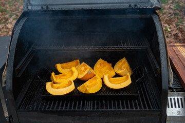 Using the smoker to roast a couple sugar pumpkins to make homemade pumpkin puree - 395013397