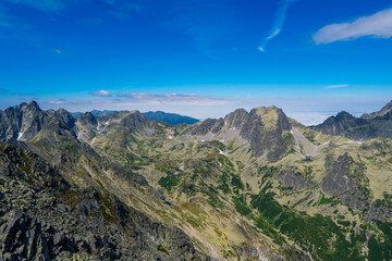 Fototapeta na wymiar Mountain stone range peak against blue cloudy sky. Nature landscape. Travel background. National Park High Tatra, Slovakia, Europe.