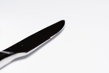 White plate with cutlery on white background