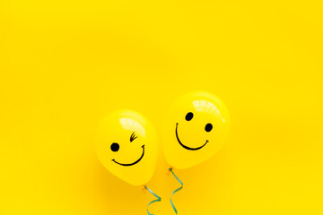 Positive emotions set. Happy and winking emoticons painted on colored balloons