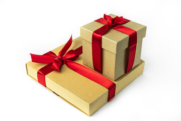 Holiday packaging, paper boxes with red ribbon . Isolated on a white background