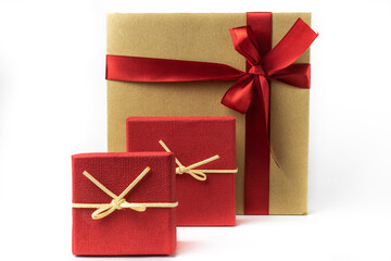 Holiday packaging, paper boxes with red ribbon . Isolated on a white background
