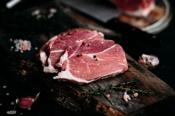 Raw pork steak on a wooden table