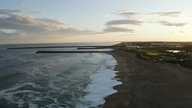 Early morning at the ocean, aerial shot of a beautiful sunrise with clouds. Located in Anglet. Surf country, Pays basque. Reflect of the sun in Adour river in southwestern France.