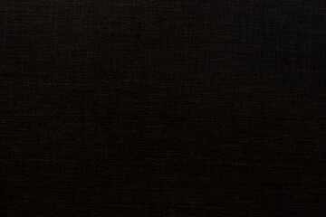 Dark brown fine patterned fabric background.