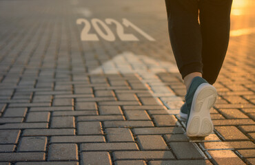 2021 start goal forward business concept. New Year 2021 movement to success, victory, career change. feet on arrow in sunlight