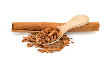 cinnamon broken and sticks with wooden spoon isolated on a white background