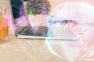 Financial graph colorful drawing and table with computer on background. Double exposure. Concept of international markets.