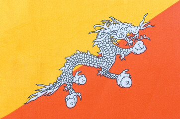 national flag of the Kingdom of Bhutan on a fabric basis close-up