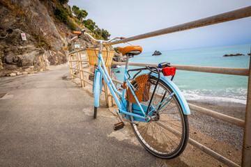 Fototapeta premium Blue bycicle at the beach of Monterosso al Mare in Cinque Terre, Italy