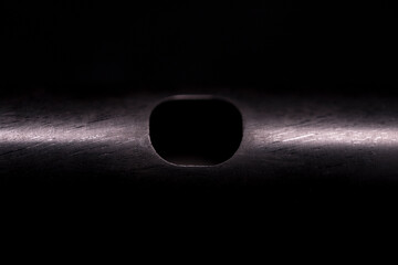 The head of a piccolo flute on a black background