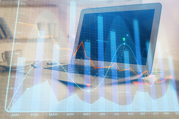 Stock market chart hologram drawn on personal computer background. Multi exposure. Concept of investment.