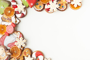 Christmas gingerbread cookies with Santa, candy cone, ox and snowflake shaped icing on the white...