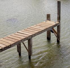 Old wooden jetty for narrowboats by Port Meadow in Oxford, UK