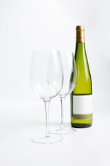 Wine bottle and two wine glasses. Wine bottle against a white background