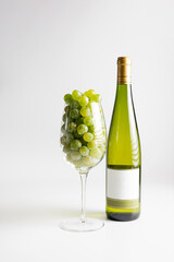 Wine bottle and two wine glasses. Wine bottle against a white background