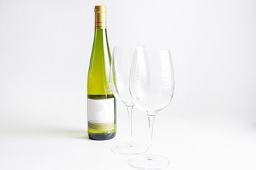Wine bottle and two wine glasses. Wine bottle against a white background