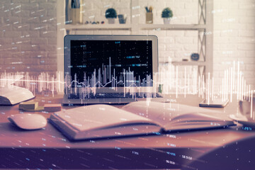 Financial graph colorful drawing and table with computer on background. Multi exposure. Concept of...
