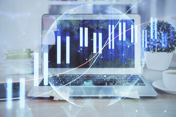 Financial graph colorful drawing and table with computer on background. Double exposure. Concept of international markets.