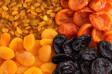 Raisins, prunes, dried fruits as a background.
