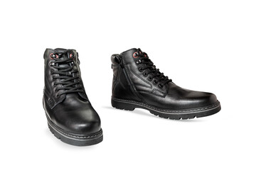 Pair of black genuine leather boots. Men's clothing.