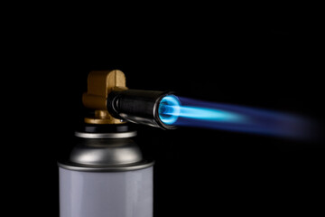 Flamethrower burner gas blow torch Ignition with blue fire flame at black background