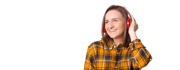 Young woman in checkered shirt enjoying music with her new headphones