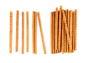 Creative layout made of crackers sticks on the white background. Food concept. Edible snack dry sticks with salt on white background. Straws, sticks crackers.