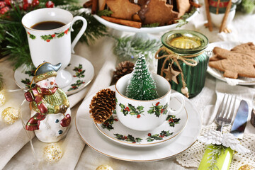 Christmas table setting in white red green colors in rustic style