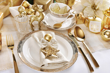 Christmas table setting in white and gold colors in glamour style