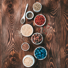 Various superfoods in small bowl on wooden table.Selection super food.Superfood as blueberry, chia,...