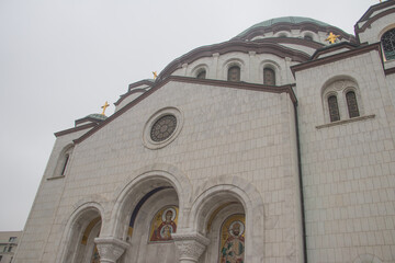 Details of Saint Sava temple (Hram Svetog Save, in Serbian), windows and cupola with golden cross on top, powerful white walls. One of biggest Orthodox temples in the world, Serbia, Belgrade