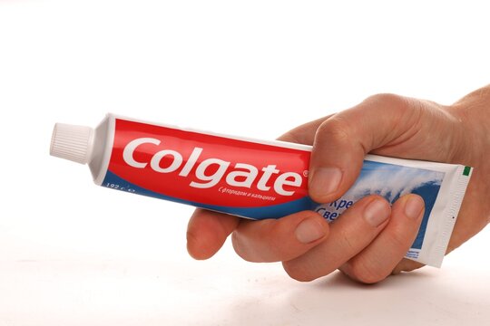 LVIV, UKRAINE - November 20, 2020: Colgate toothpaste in hands