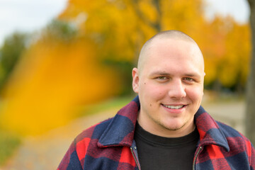 Young man in casual plaid jacket outdoors in fall