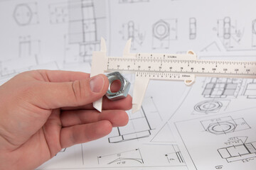 Measurement of nut dimensions with an engineering caliper. Engineer's work.