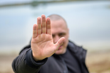 Man giving a stop or halt gesture with his hand