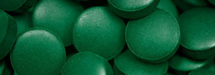 Chlorella or spirulina tablets close up. Nutrition and dietary dupplements. Vegan Protein.