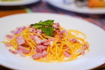 spaghetti carbonara with ham and parmesan cheese