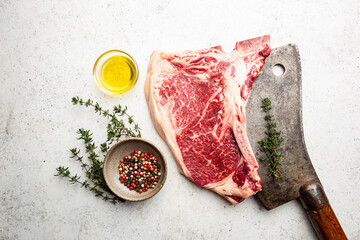 Raw fresh meat T-bone beef Steak and butcher knife on white background, top view