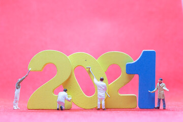 Miniature worker team painting number 2021  , Happy new year concept
