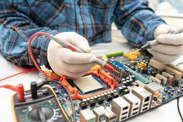 technician repairing inside of hard disk by soldering iron. Integrated Circuit. the concept of...