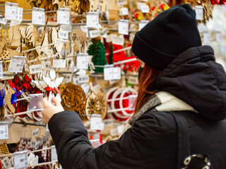 A girl chooses accessories in a Christmas goods store during a corona virus quarantine COVID-19