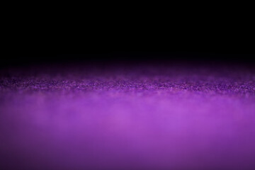 An illuminated purple carpet in the dark