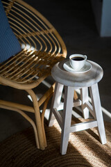 Cup of coffee on the table in the sun light